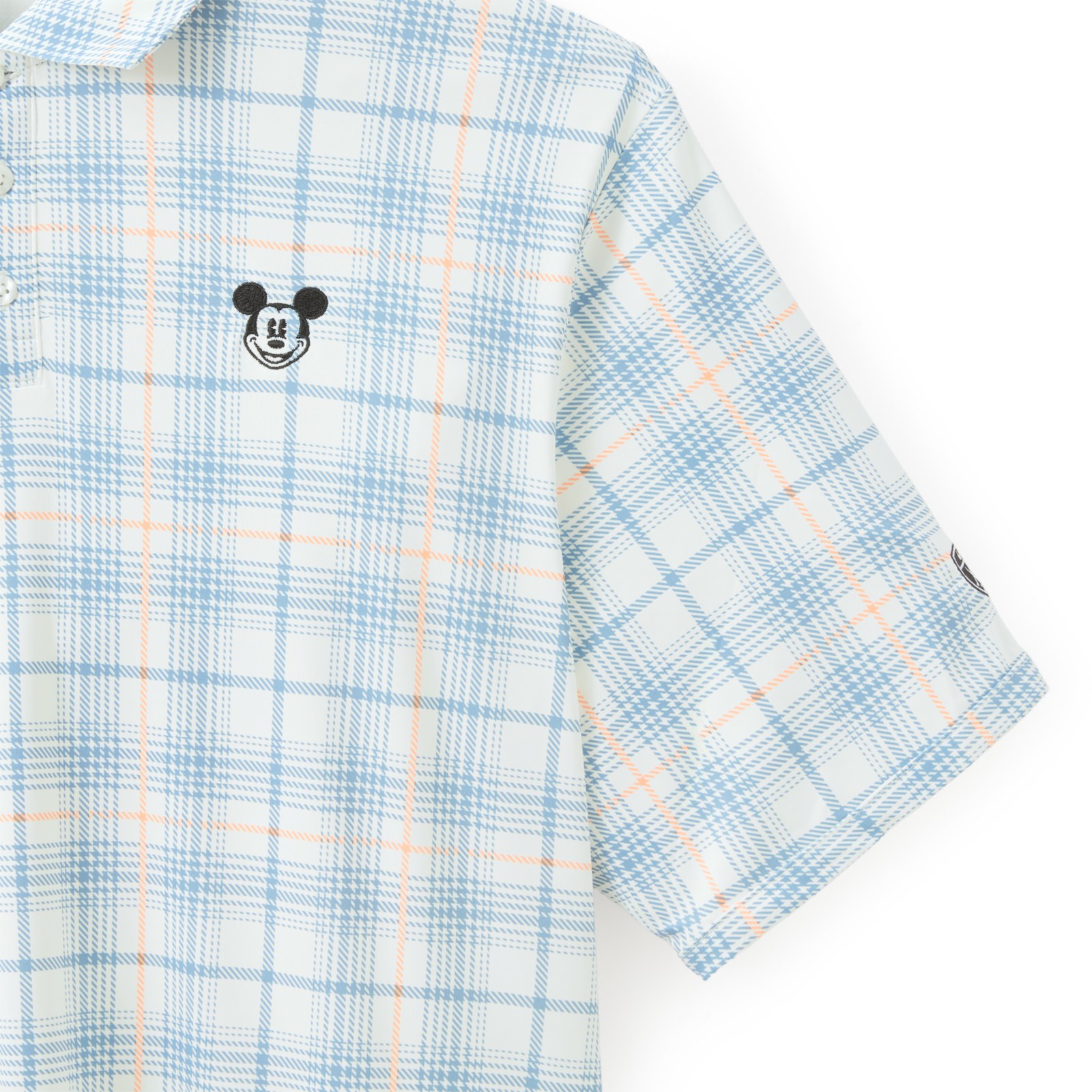 Close view of Mickey Mouse embroidery on the plaid Nike polo