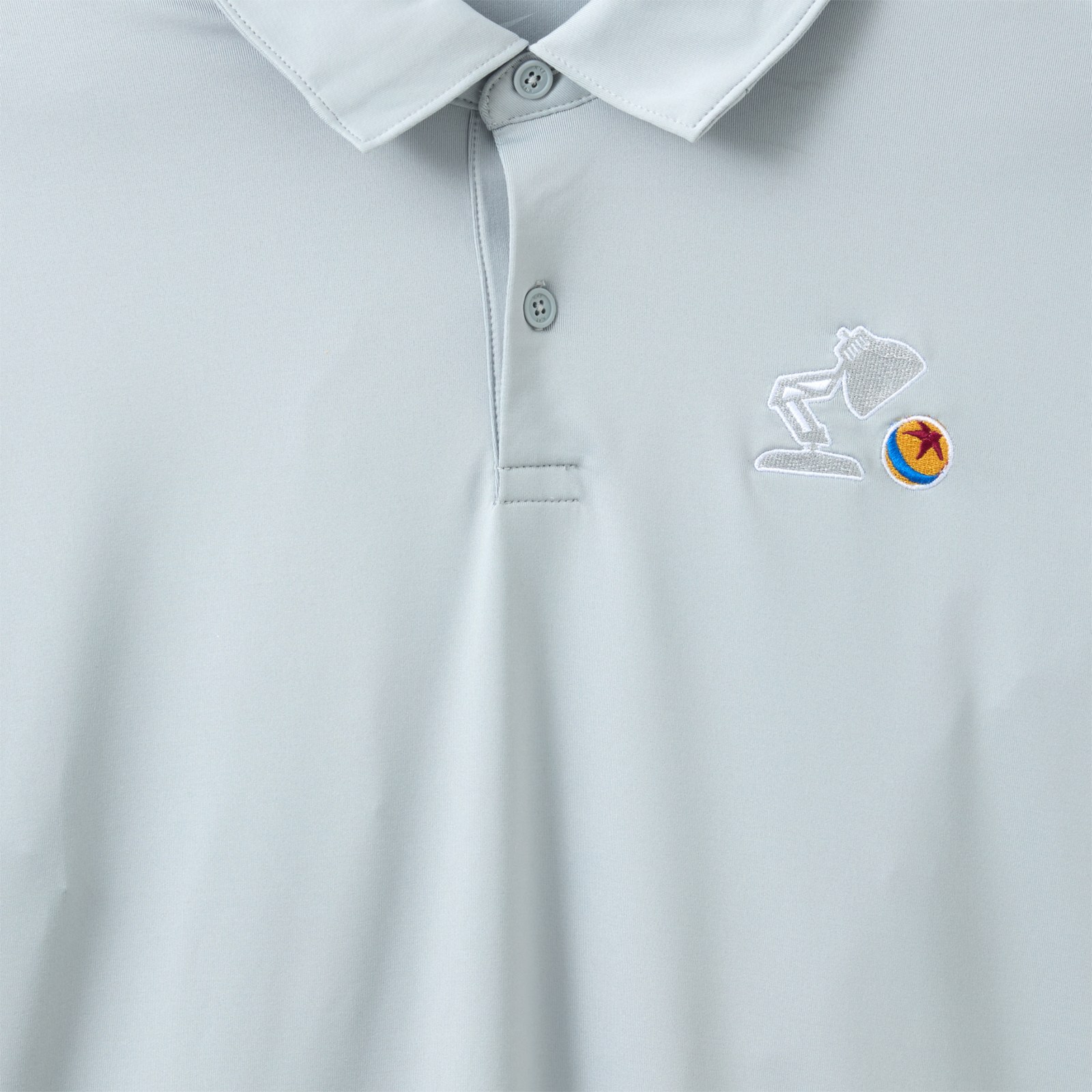 Close view of Luxo Jr. and Pixar Ball embroidery on the Nike polo