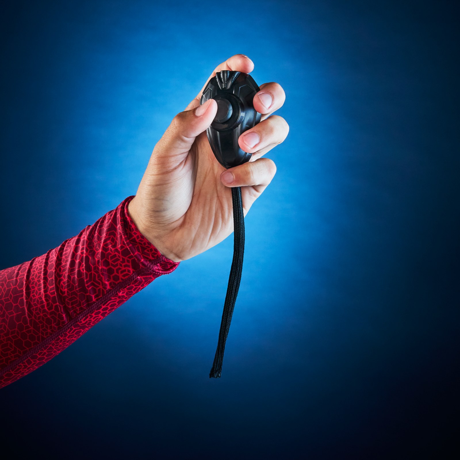 Hand holding the wired remote for the Spider-Man expressive mask
