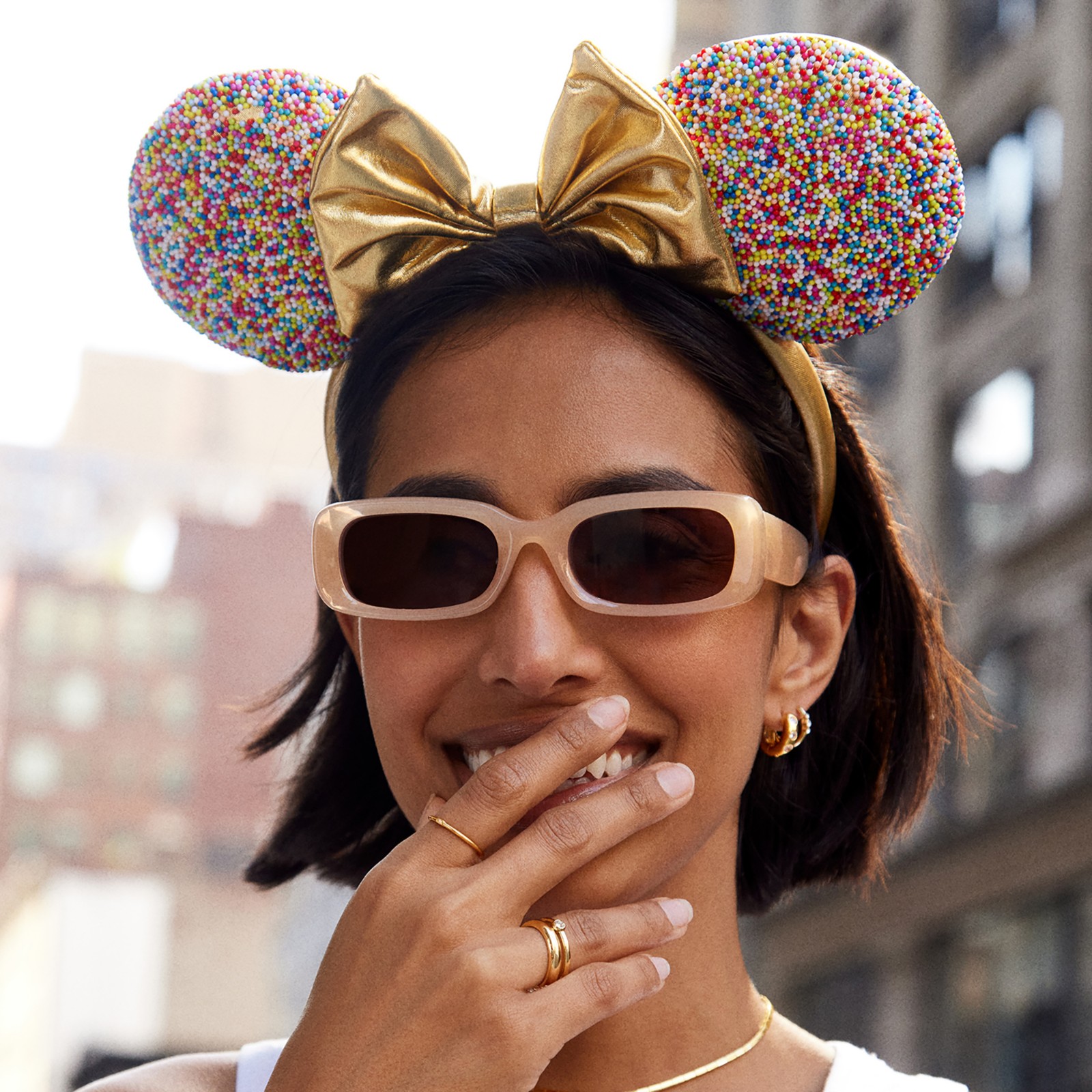 Angled view of the gold confetti Minnie Mouse ear headband
