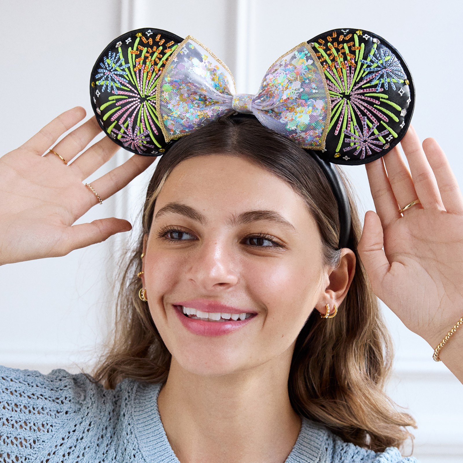 Angled view of the black fireworks Minnie Mouse ear headband