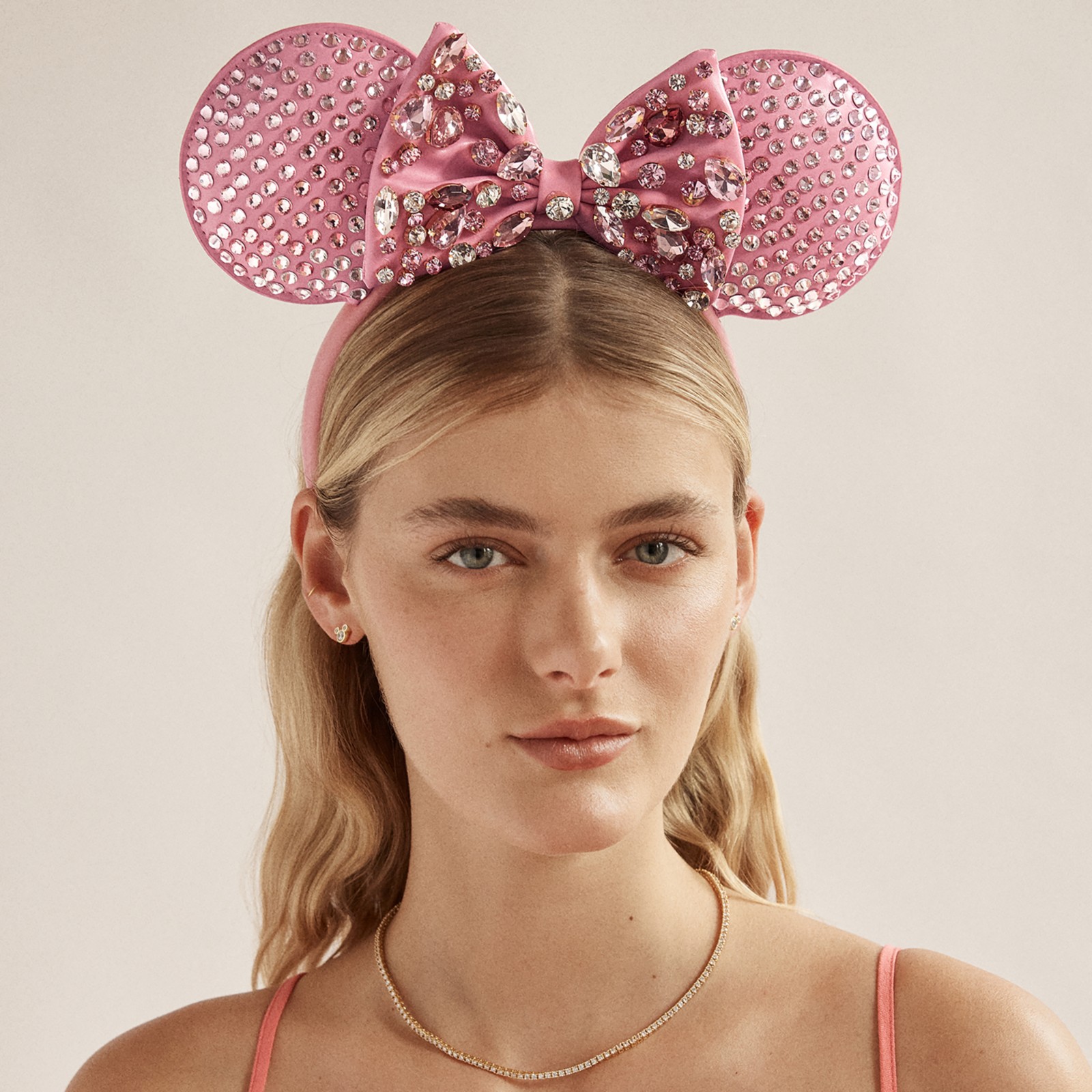 Angled view of the pink crystal Minnie Mouse ear headband