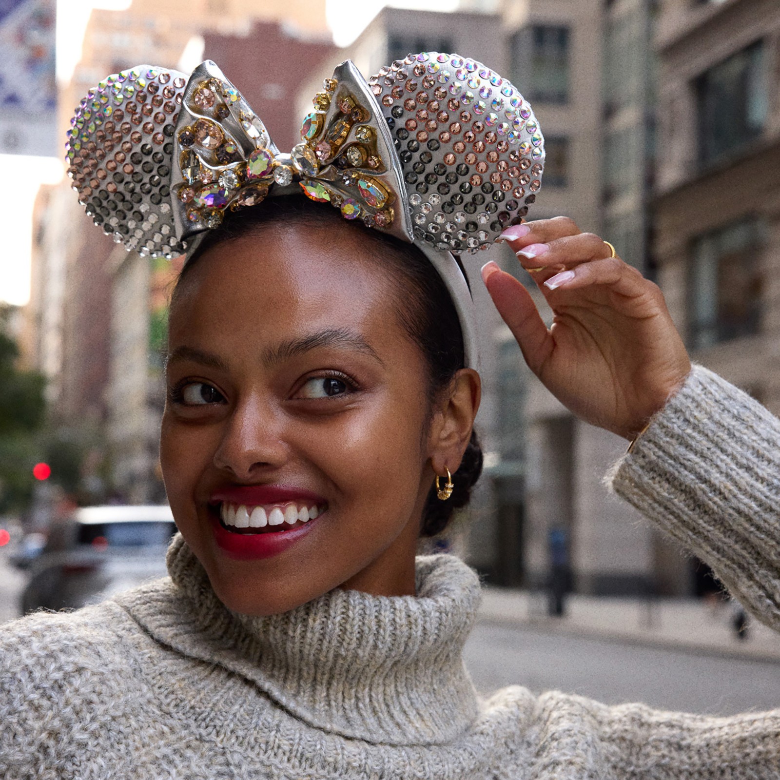 Angled view of the silver crystal Minnie Mouse ear headband