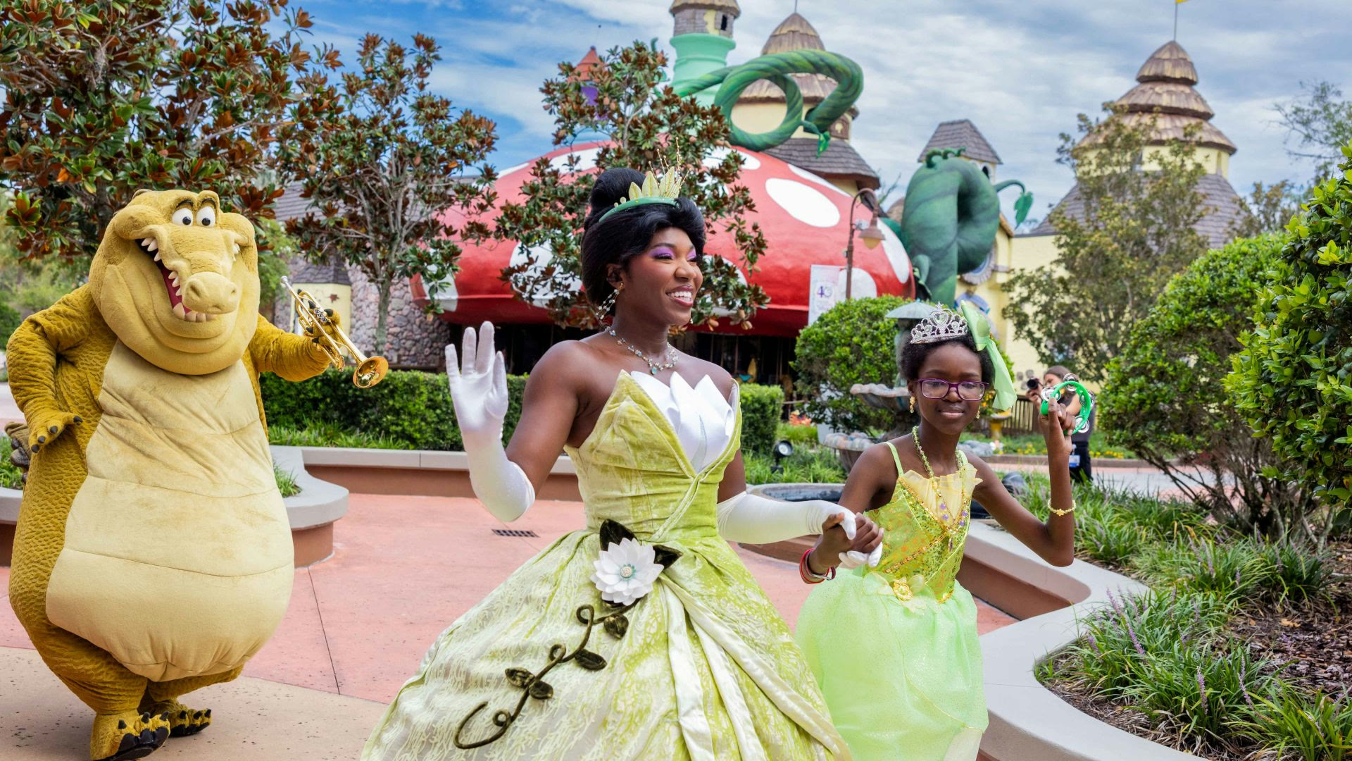 Princess Tiana, Louis and a child at Give Kids The World Village