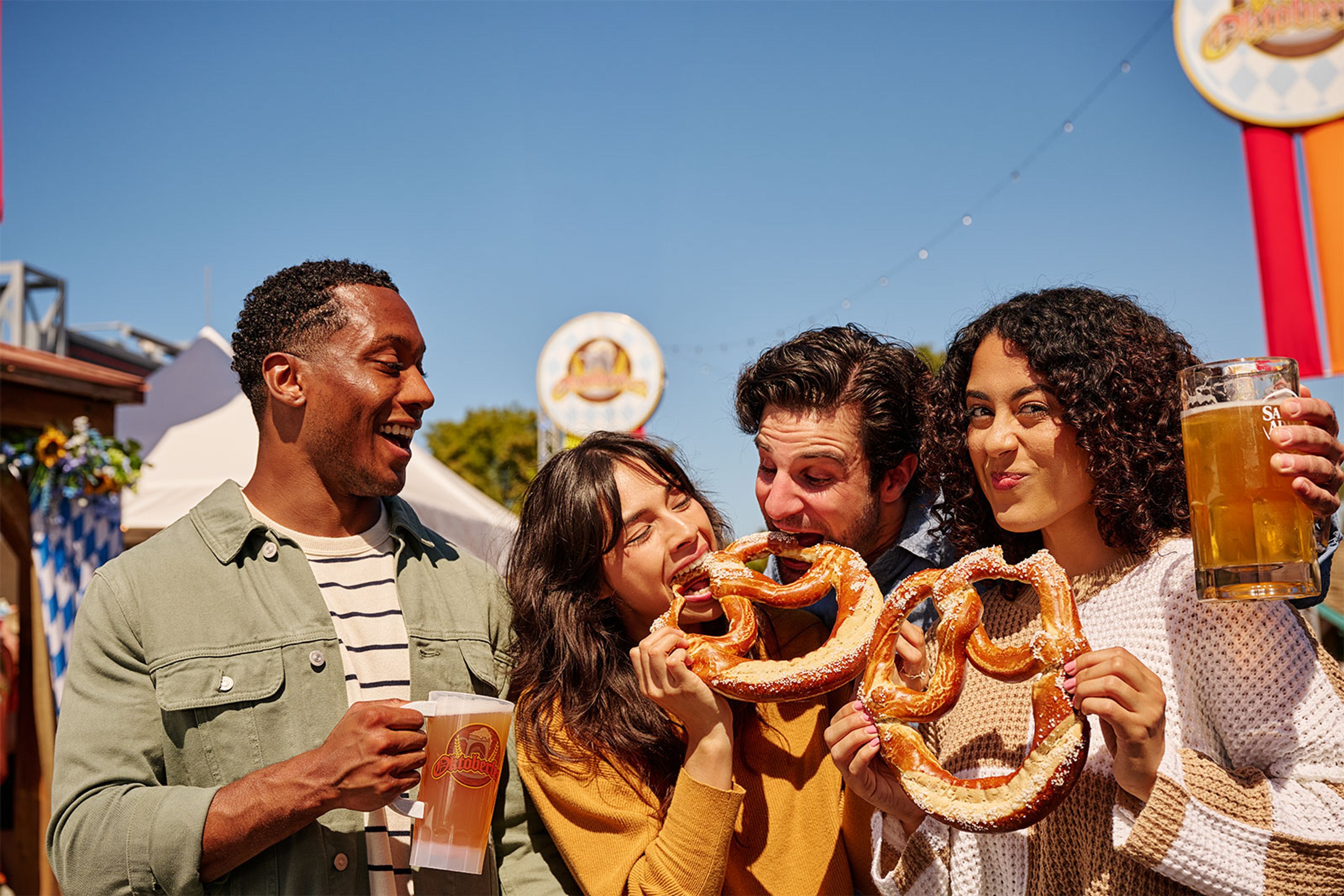 Visitors share pretzels and beer during Oktoberfest at Six Flags Fiesta Texas