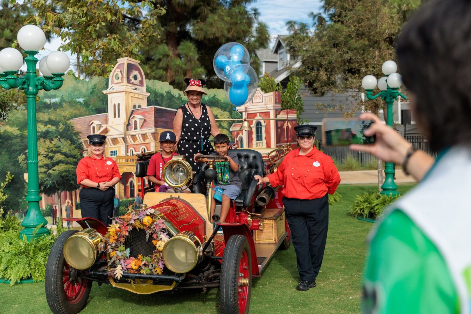 Anaheim residents pose with the Disneyland Resort Fire Engine at Center Greens Park