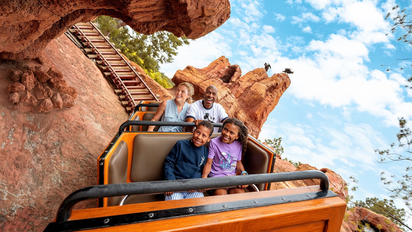 Family riding Big Thunder Mountain at Disneyland Resort