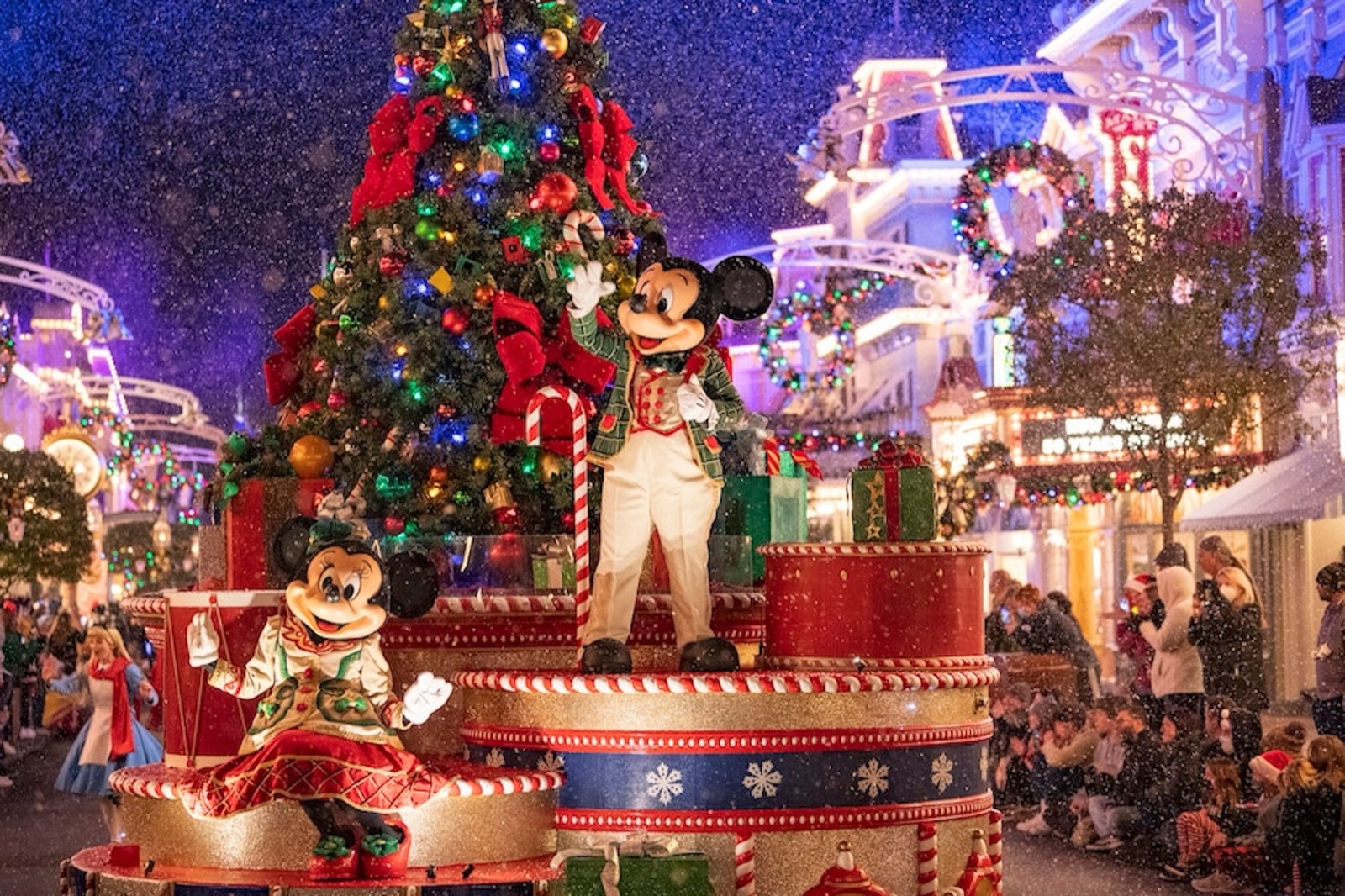 Mickey and Minnie on a holiday parade float during Mickey’s Very Merry Christmas Party