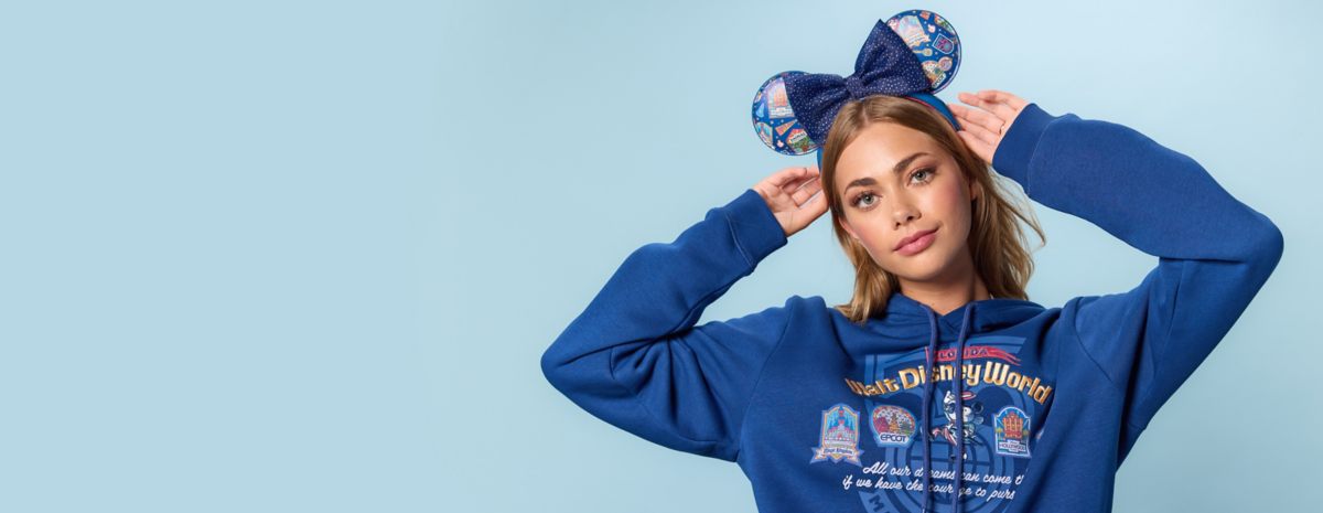 Blue Walt Disney World hoodie and park-icon ear headband in Disney Store's 55th-anniversary preview