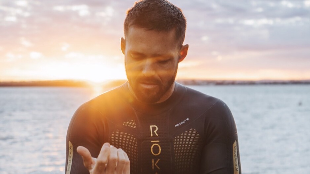Spencer Matthews in a wetsuit at sunset for the official Breaking Spencer Matthews documentary announcement