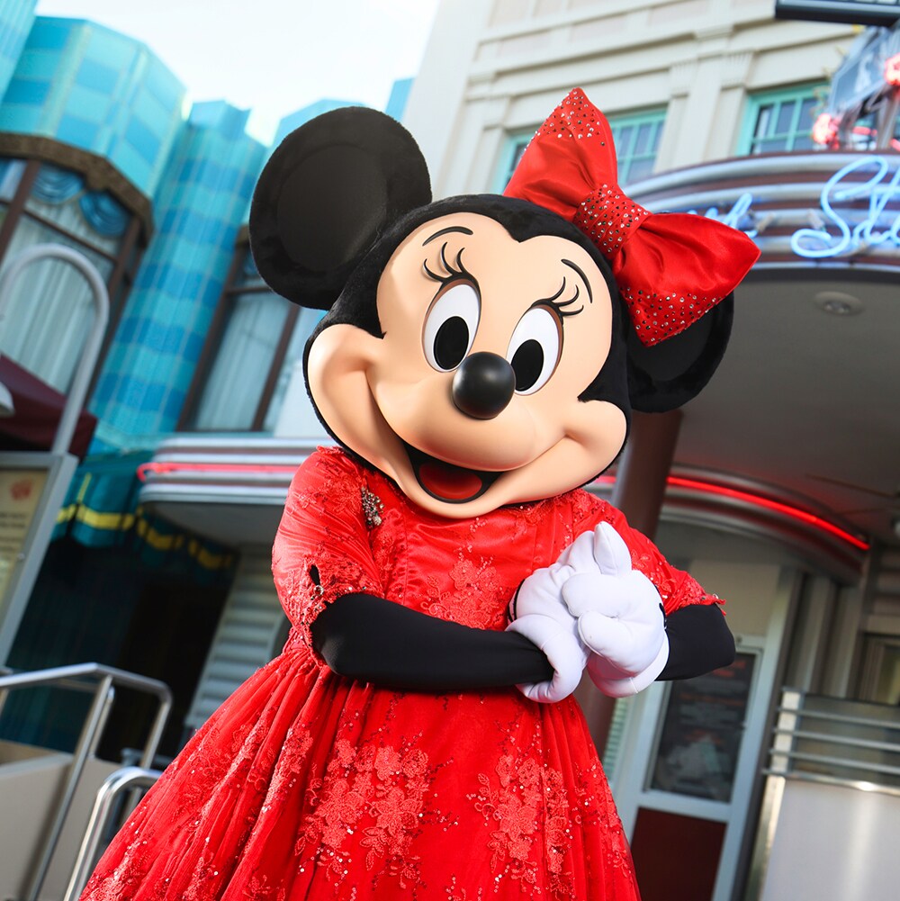 Minnie Mouse in a red holiday dress outside Hollywood & Vine
