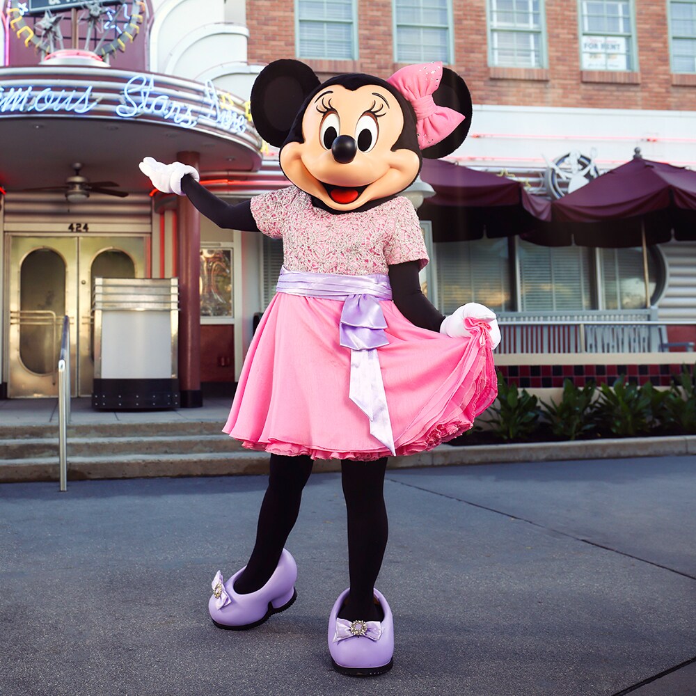 Minnie Mouse in a pink dress outside Hollywood & Vine