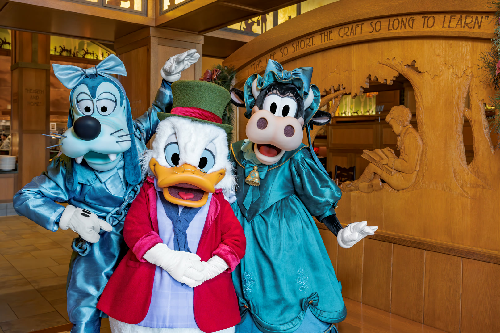 Disney characters in seasonal outfits inside Storytellers Cafe