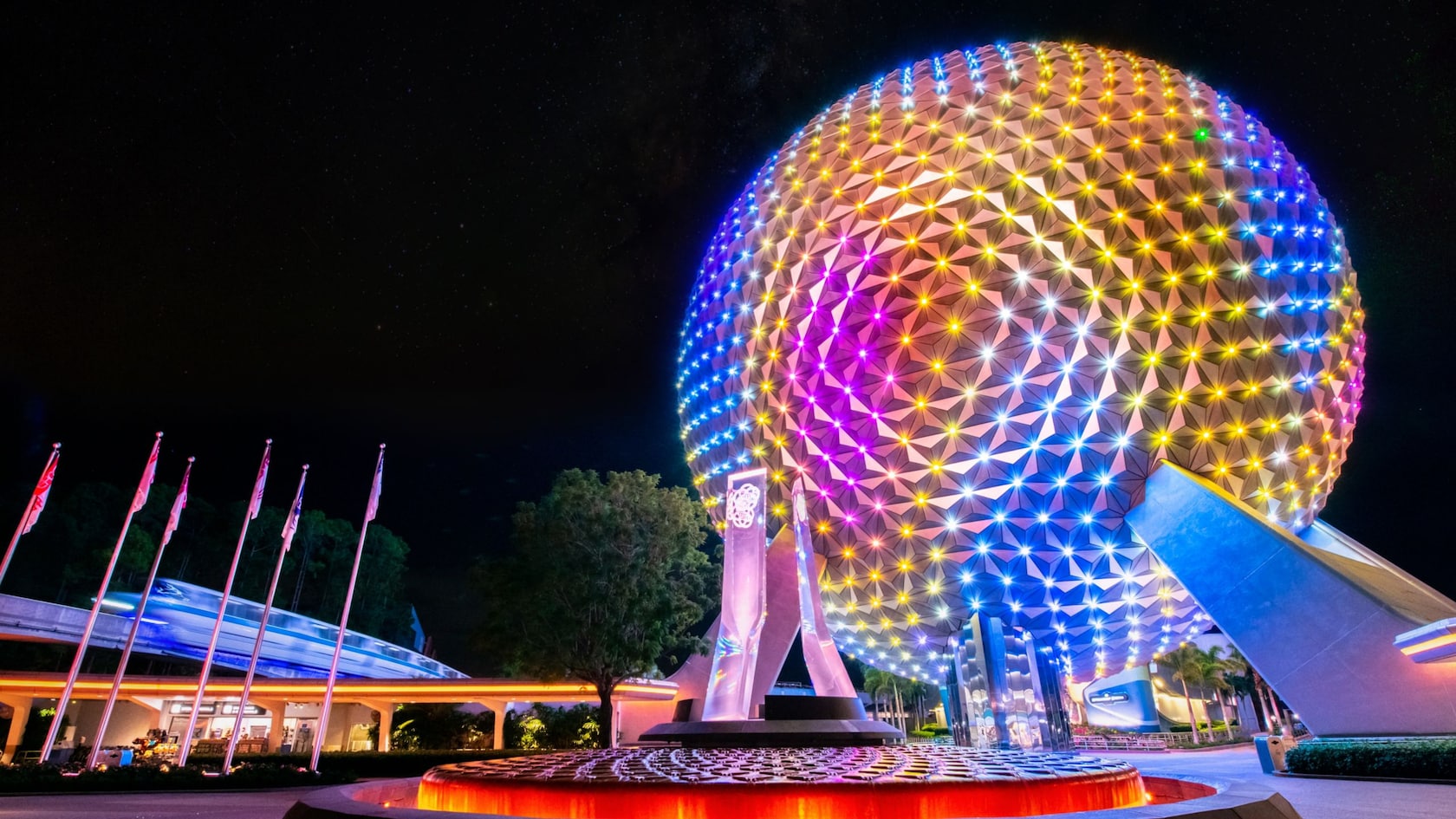 Spaceship Earth glowing at EPCOT at night
