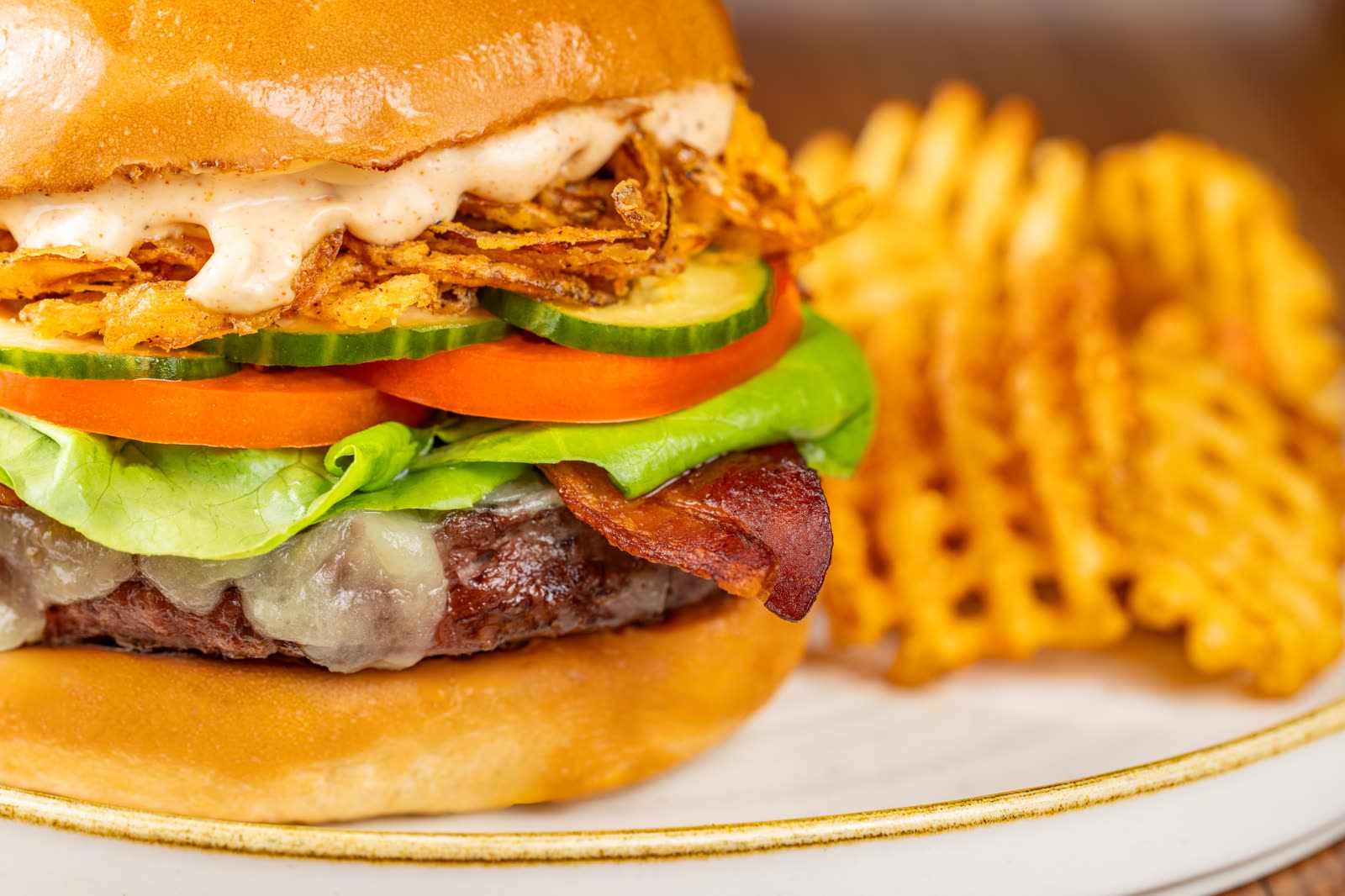 A burger and fries photographed for The Turf Club Lounge announcement