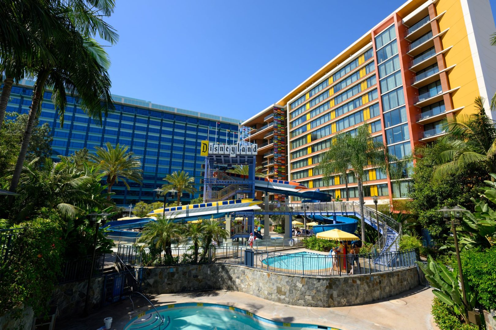 Disneyland Hotel pool area with two Monorail waterslides and colorful towers
