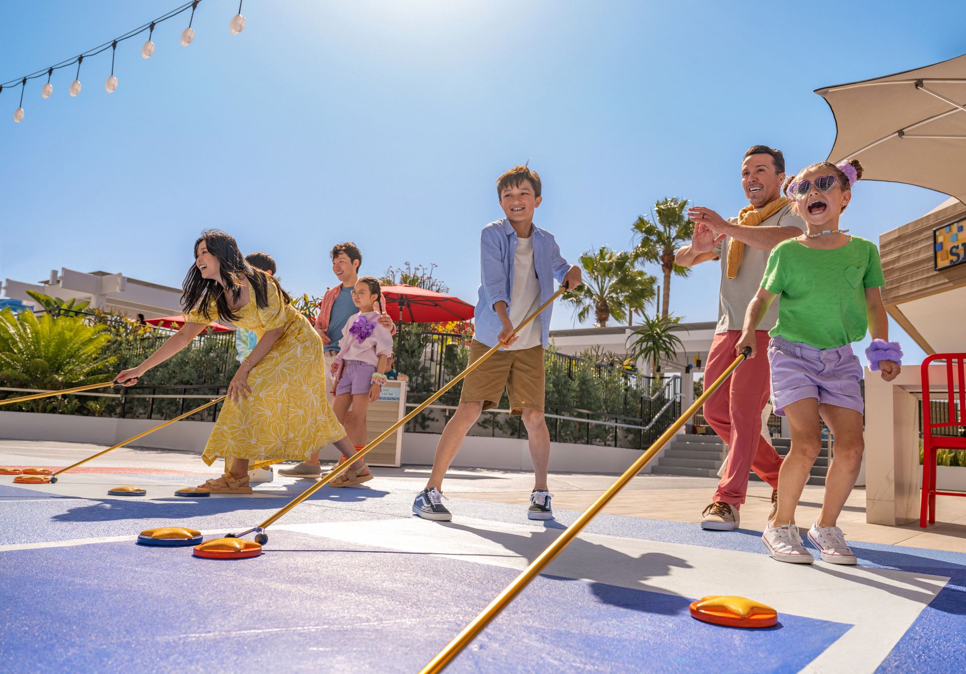 Family playing Pixar Shorts Court outside Pixar Place Hotel