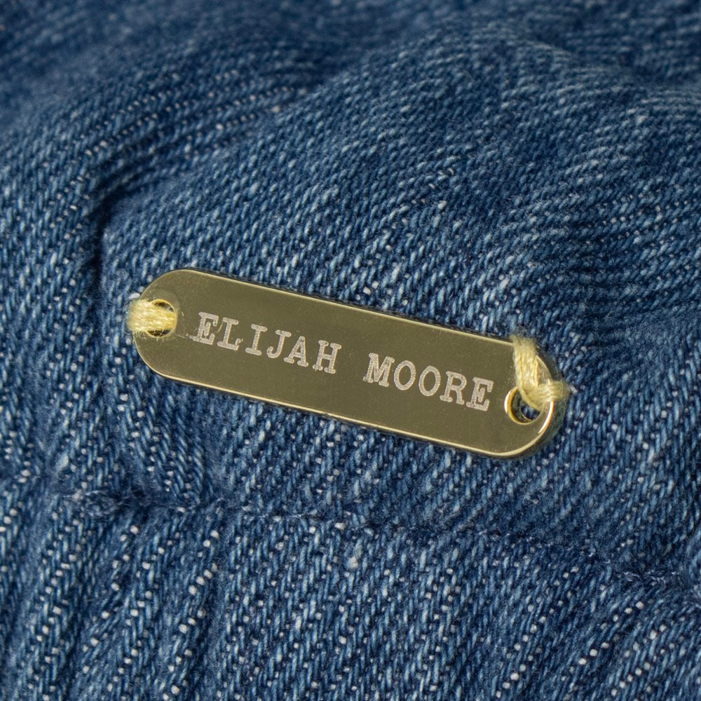 Close-up of the Elijah Moore nameplate on the Halloween Horror Nights 2026 Sinners Flat Cap