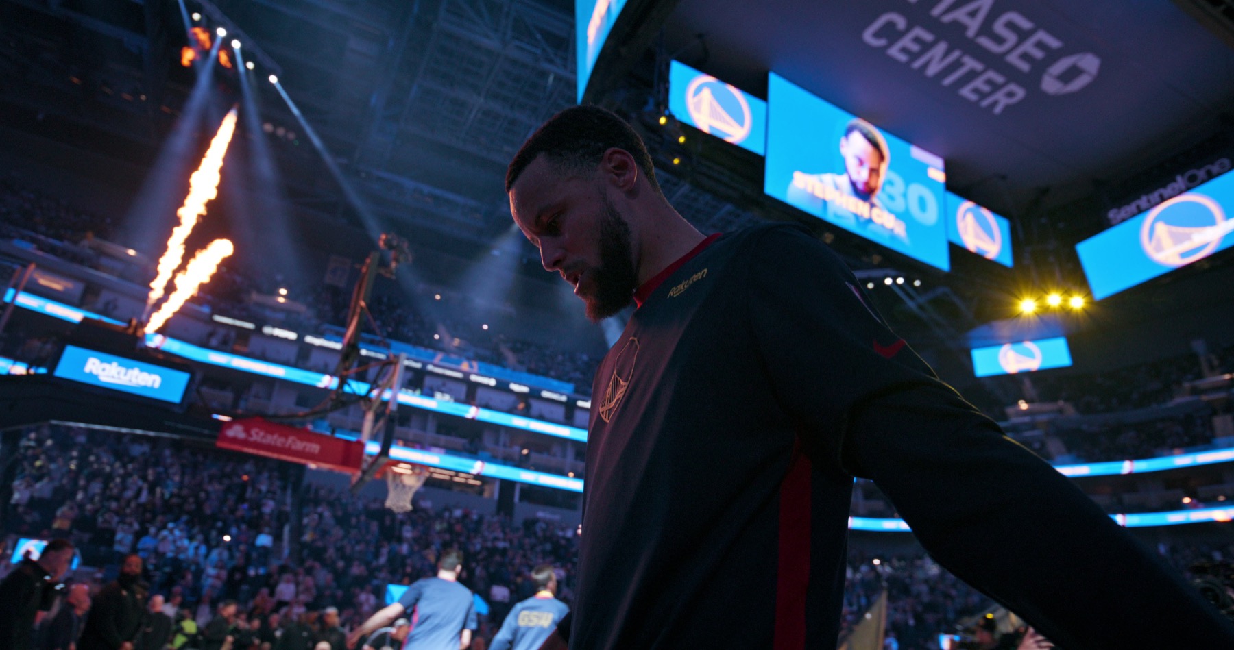 Stephen Curry on a basketball court beneath arena lights