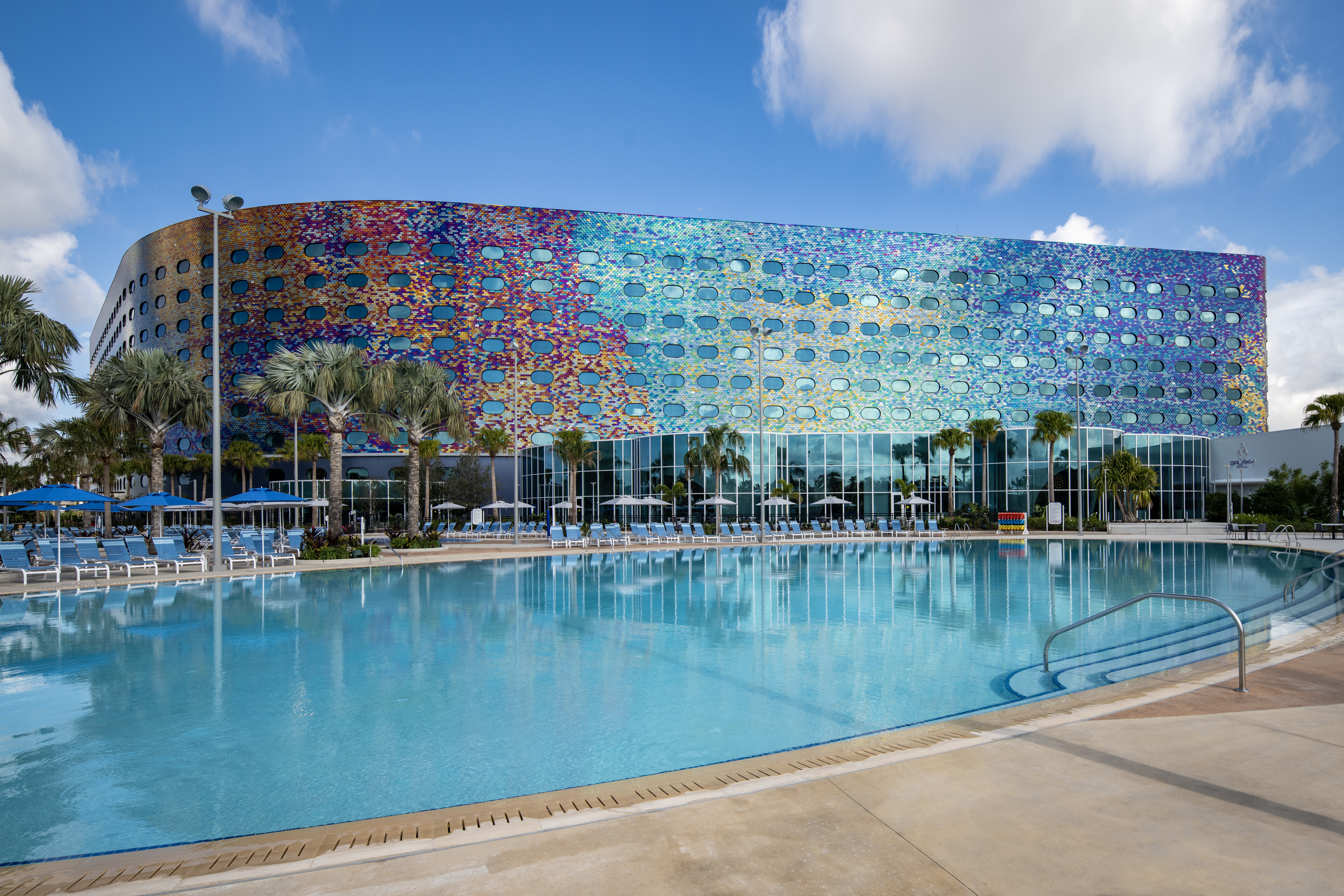 Stella Nova Resort pool with its colorful mosaic exterior and lounge deck