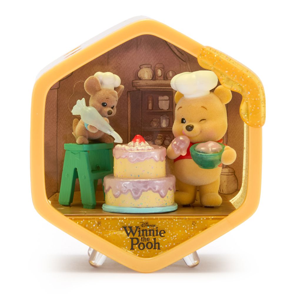 Winnie the Pooh and a friend sharing a cake in a Honeycomb Homes scene