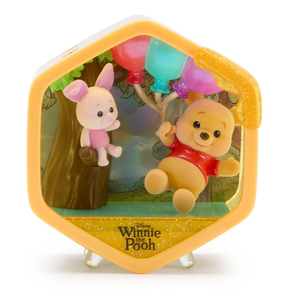 Winnie the Pooh and Piglet beneath colorful balloons in a Honeycomb Homes scene