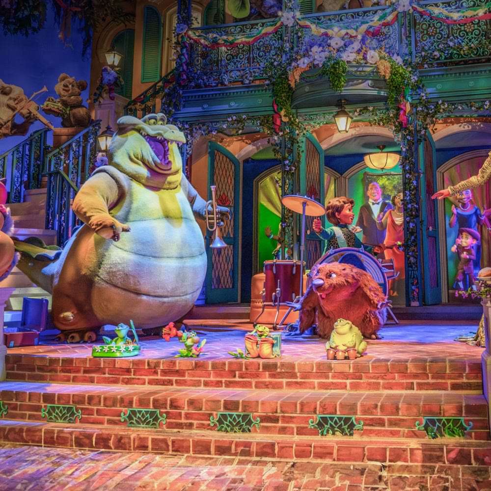 Louis and other musicians perform inside Tiana's Bayou Adventure at Disneyland Park