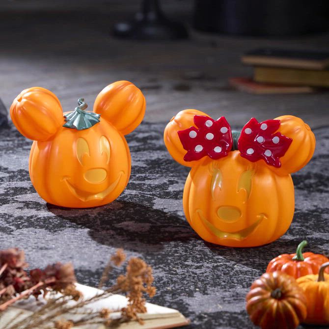 Orange Mickey and Minnie jack-o'-lantern decor displayed with other pumpkins