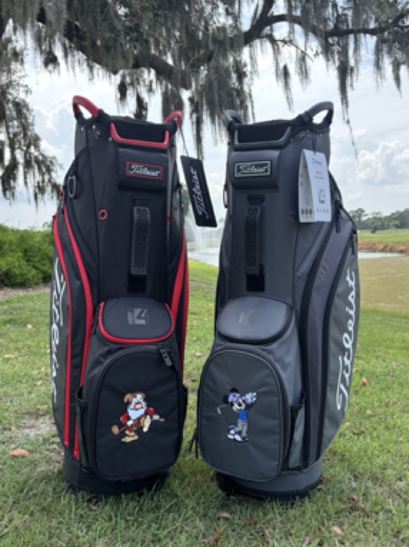 Grumpy and Mickey Mouse character-inspired Titleist golf bags beside a Walt Disney World golf course