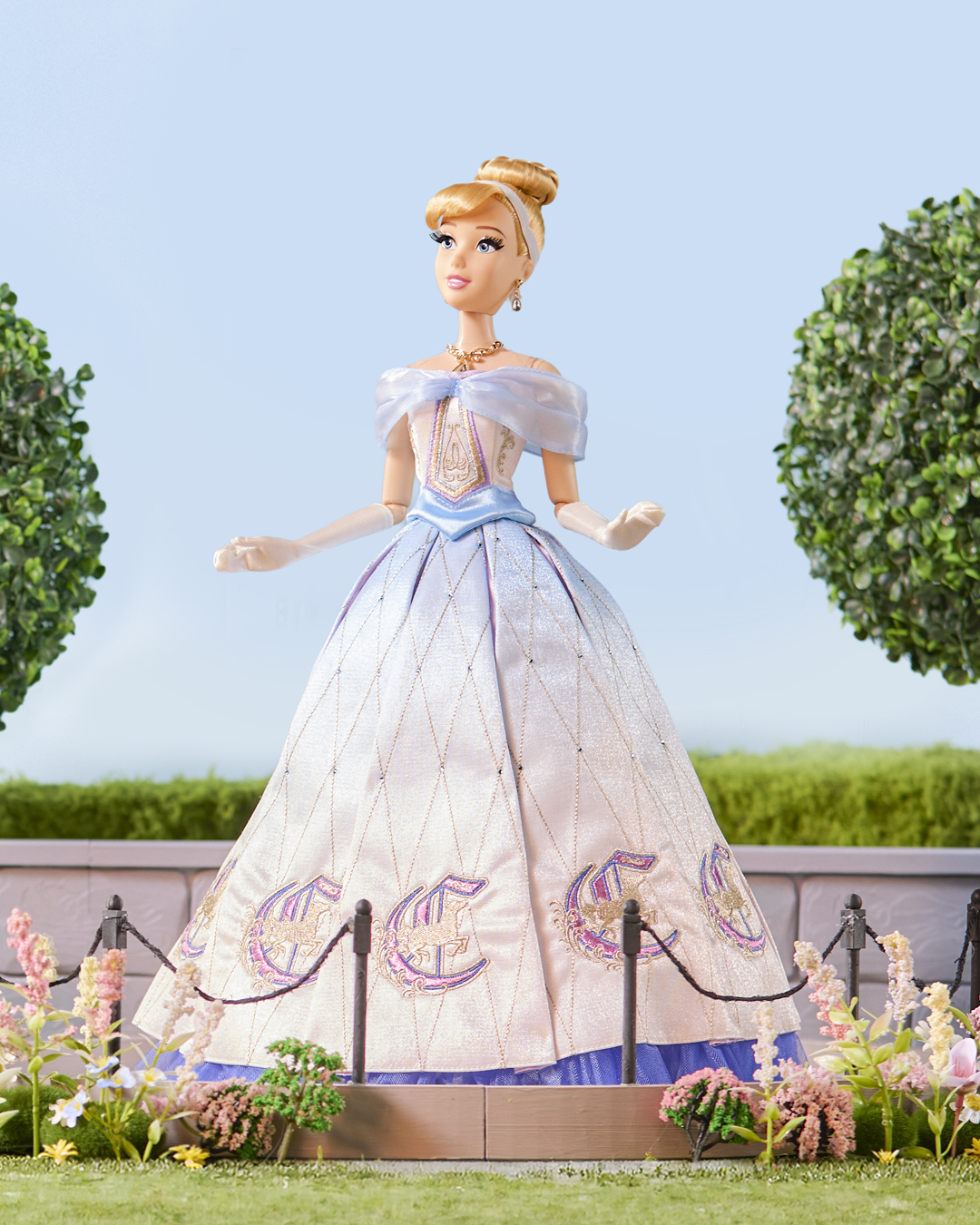 Cinderella doll standing in a flower garden display