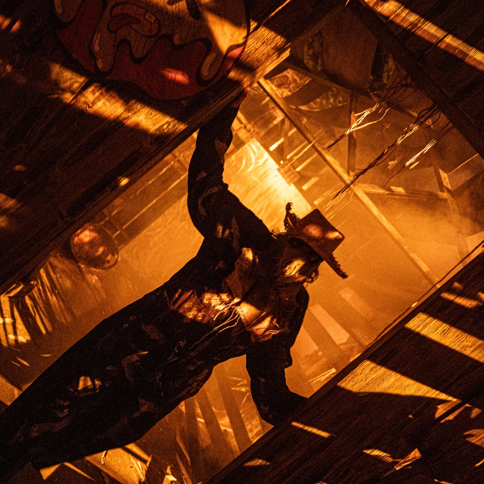 A Halloween performer appears in an orange-lit Dorney Park scene