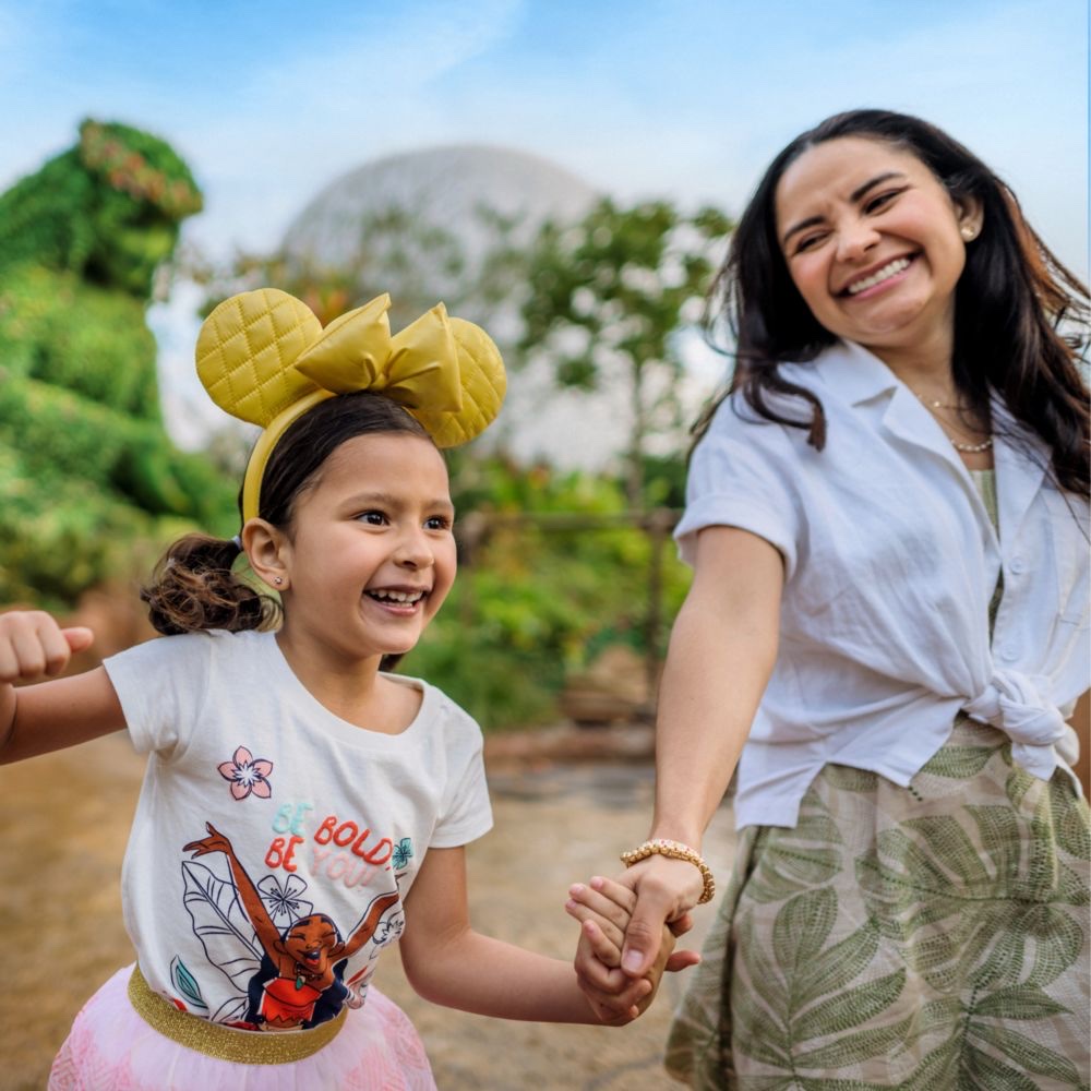 A child and adult wearing Disney headwear at Walt Disney World