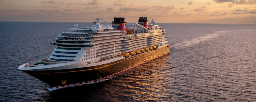 Disney Cruise Line ship sailing at sunset