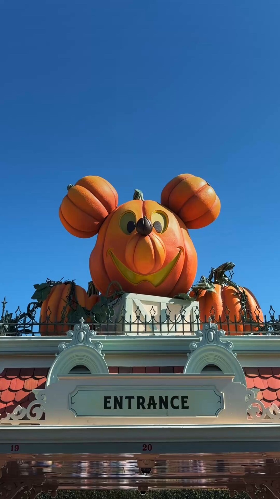 Pumpkin-shaped Mickey decoration above a Disneyland entrance