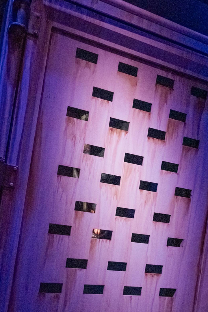 Bravo the Velociraptor visible inside her containment at Universal's Great Movie Escape