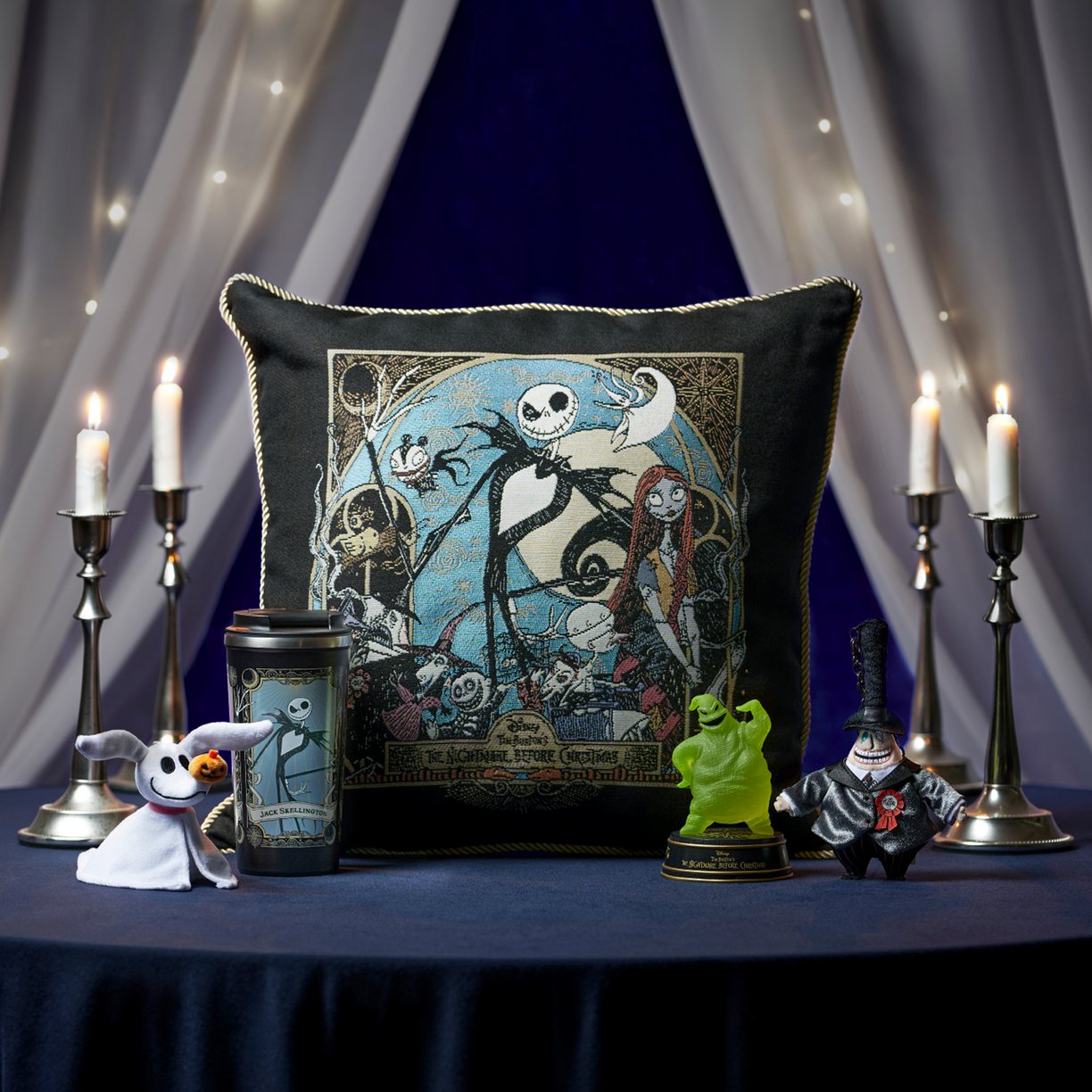 The Nightmare Before Christmas collection cushion and character goods arranged in a candlelit scene
