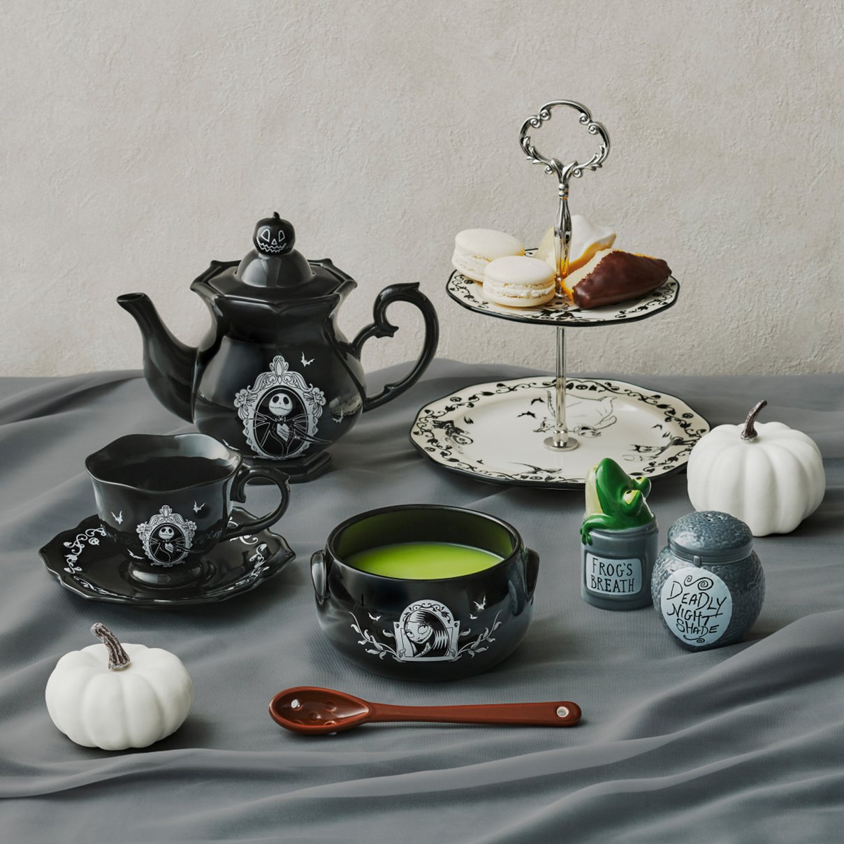 Black and white Nightmare Before Christmas tableware arranged with desserts and seasonal decor