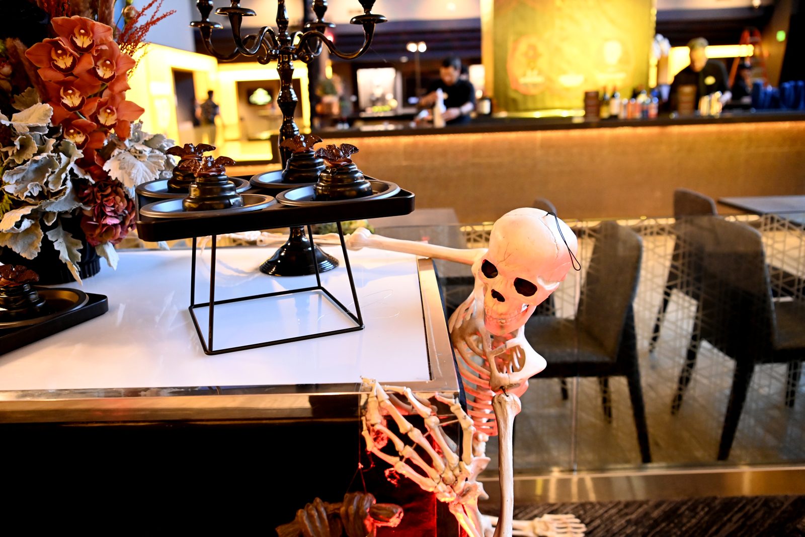 Skeleton decorations beside the food service