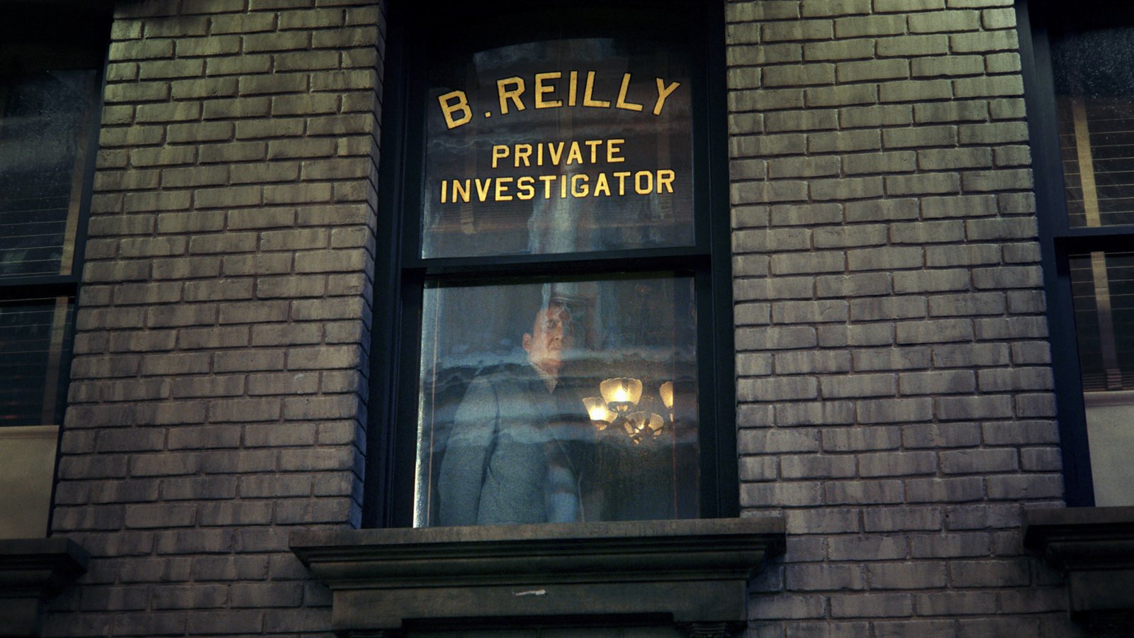 Ben Reilly behind the illuminated window of his private investigator office