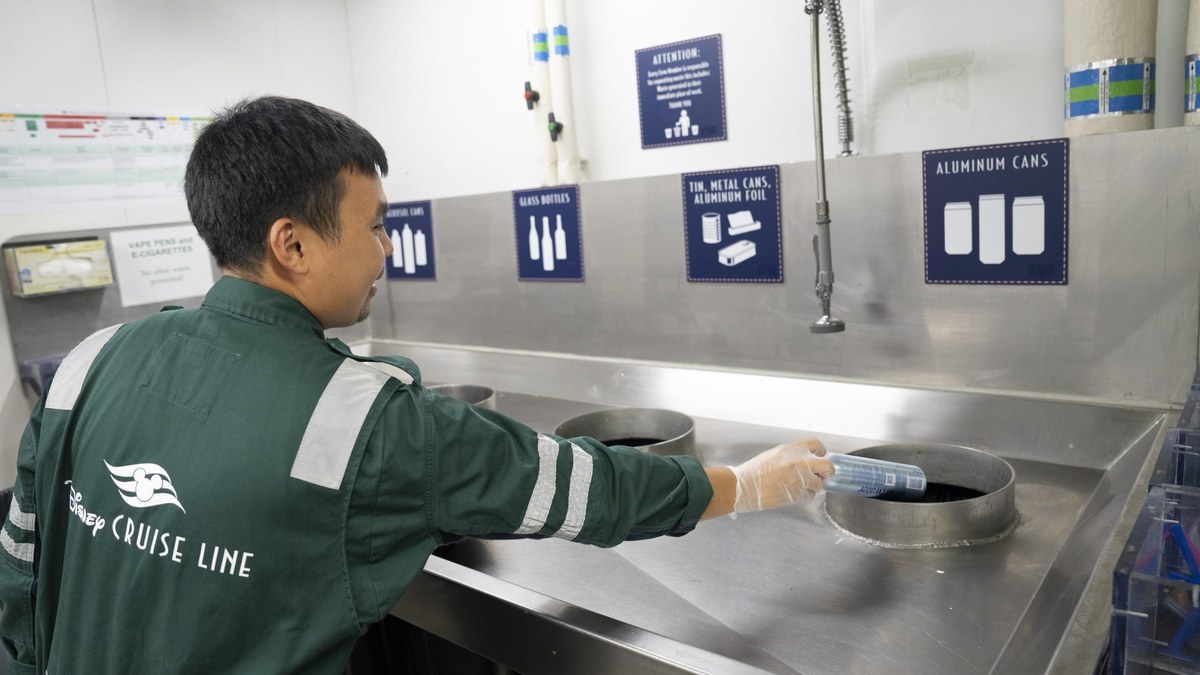 Disney Cruise Line crew member sorts recyclables in a shipboard recycling room