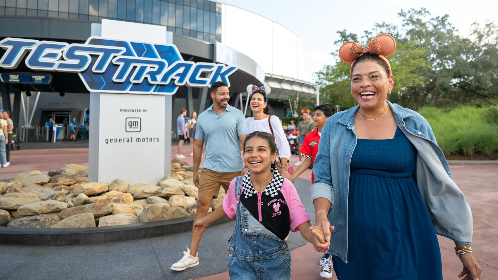 A family walking outside Test Track at EPCOT