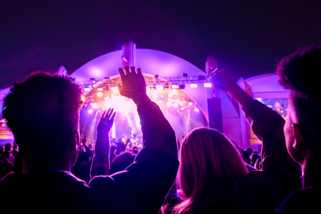 Guests raise their hands during a Rock the Universe concert at Universal Studios Florida
