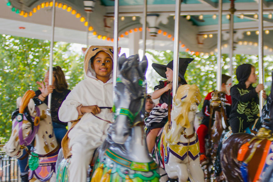 A child riding the carousel during Hersheypark Halloween