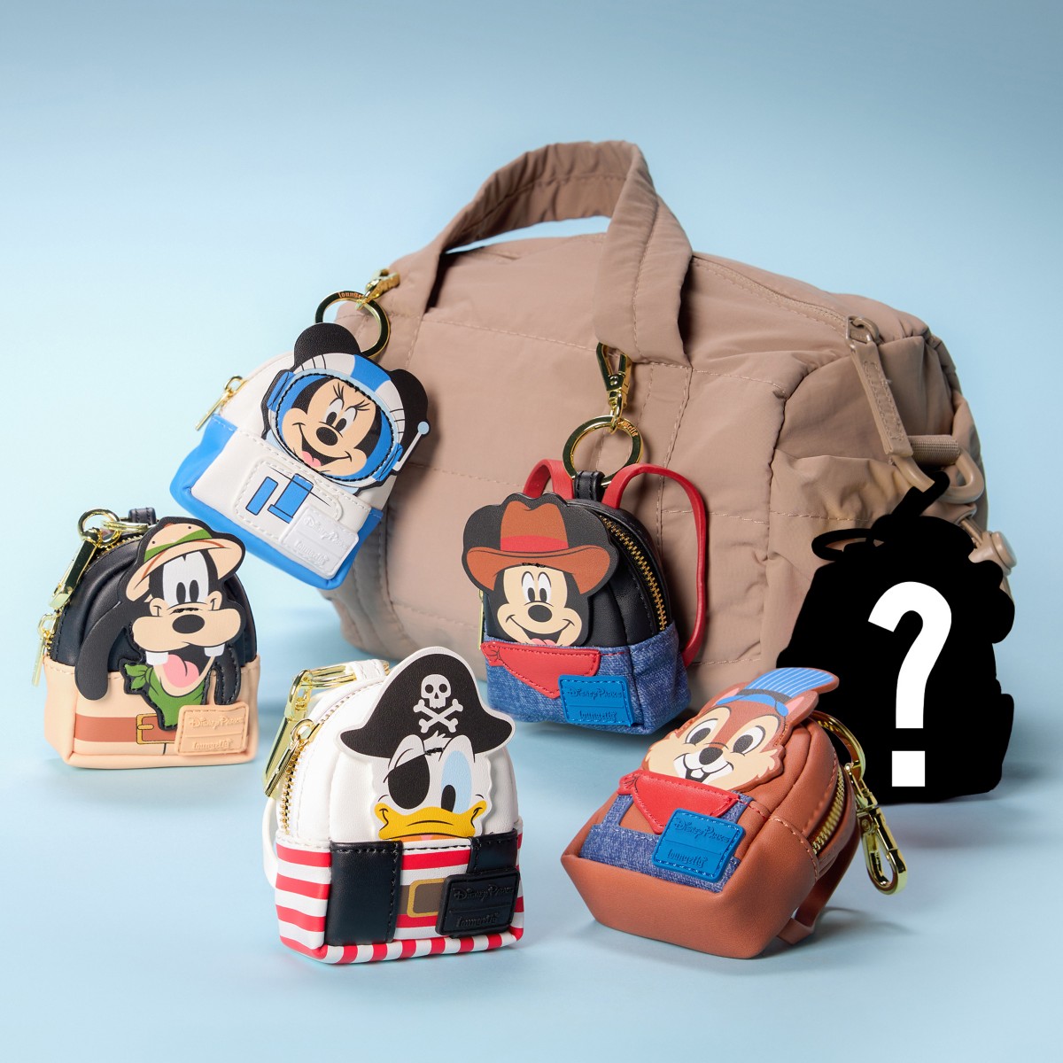 Disney attraction-costume Loungefly charms displayed on a bag