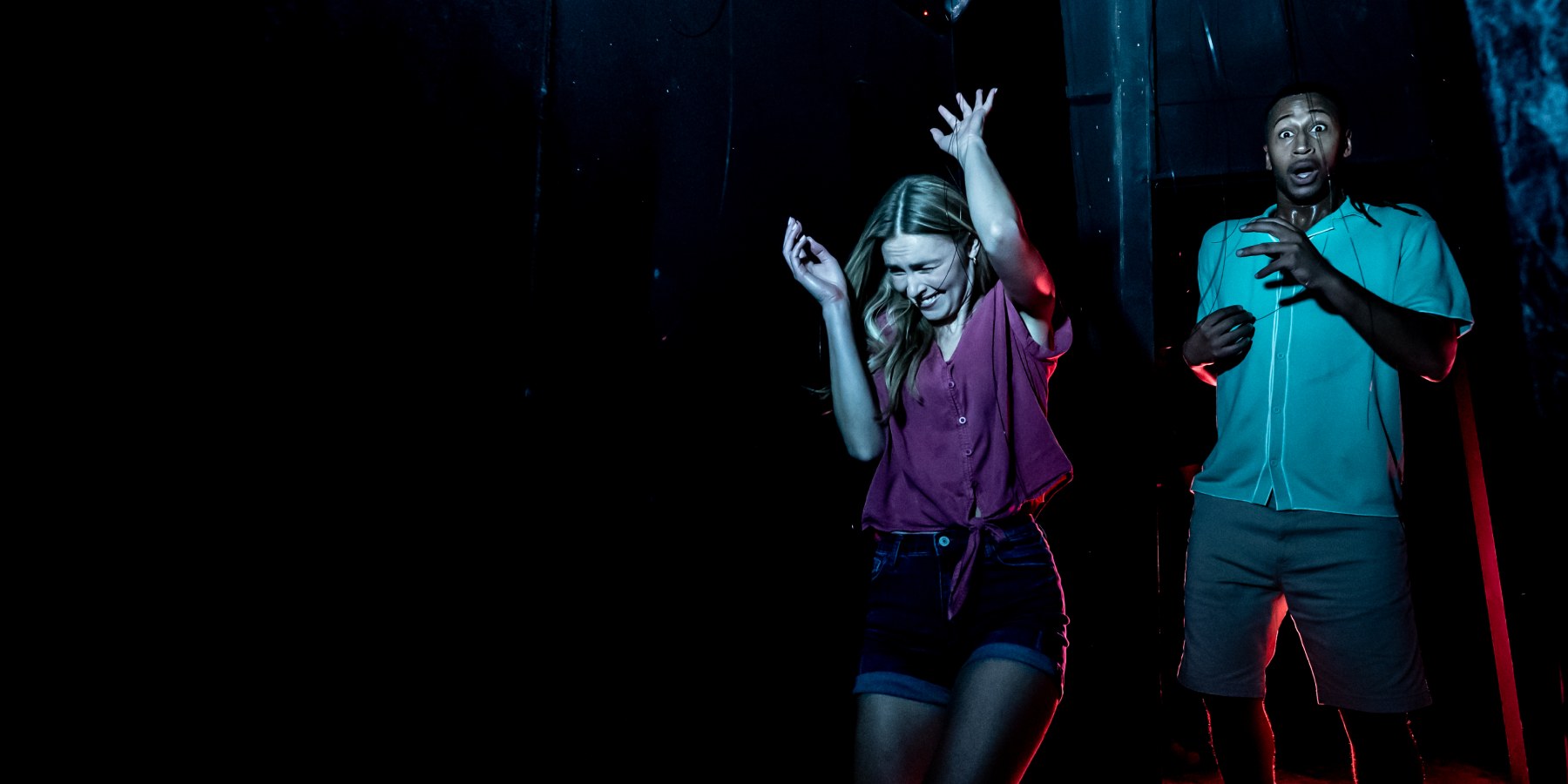 Two guests react inside a SeaWorld Orlando Howl-O-Scream haunted house
