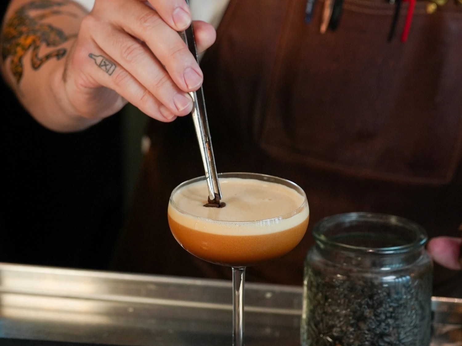 A bartender finishes a cocktail at Wine Bar George