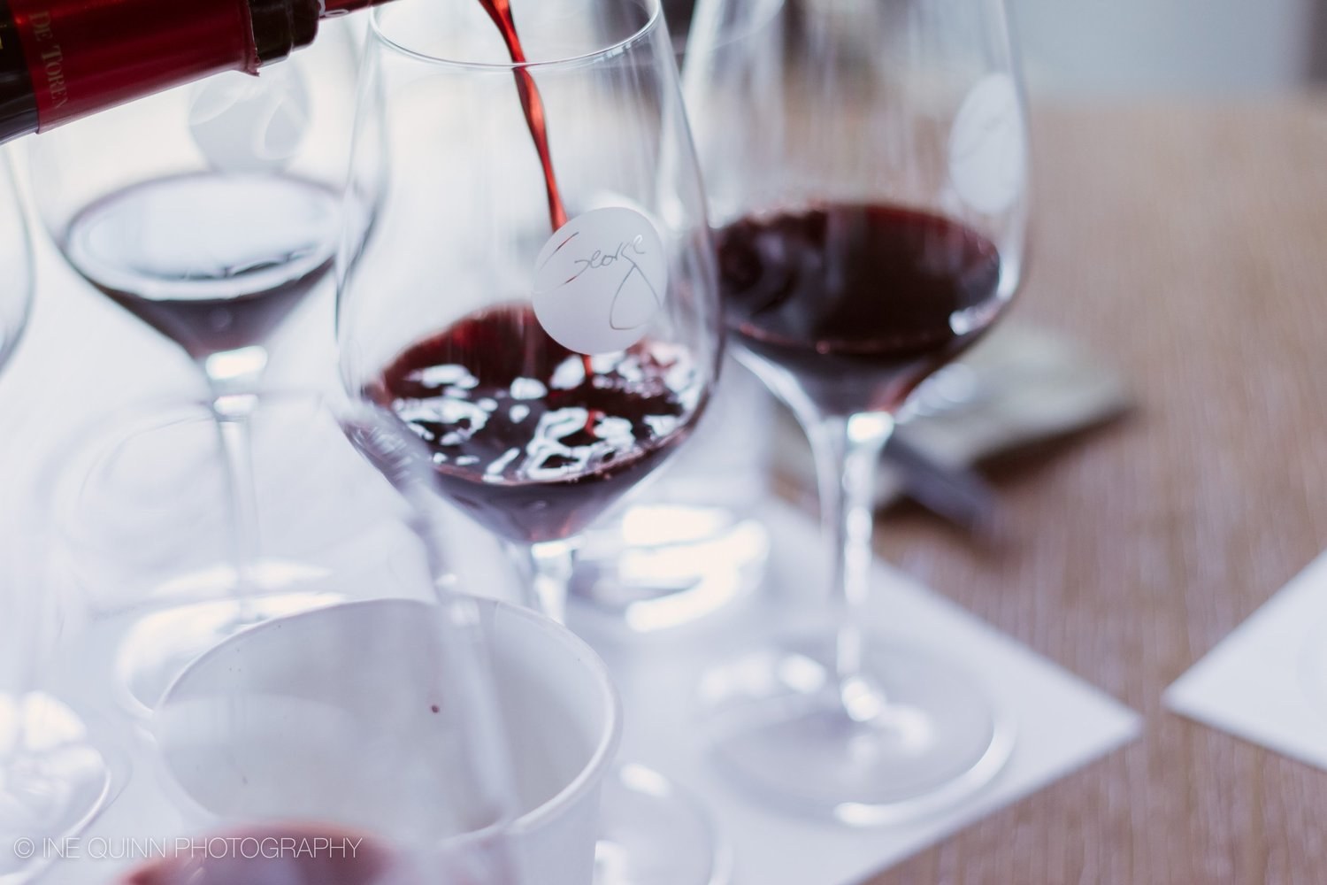 Red wine poured into tasting glasses at Wine Bar George