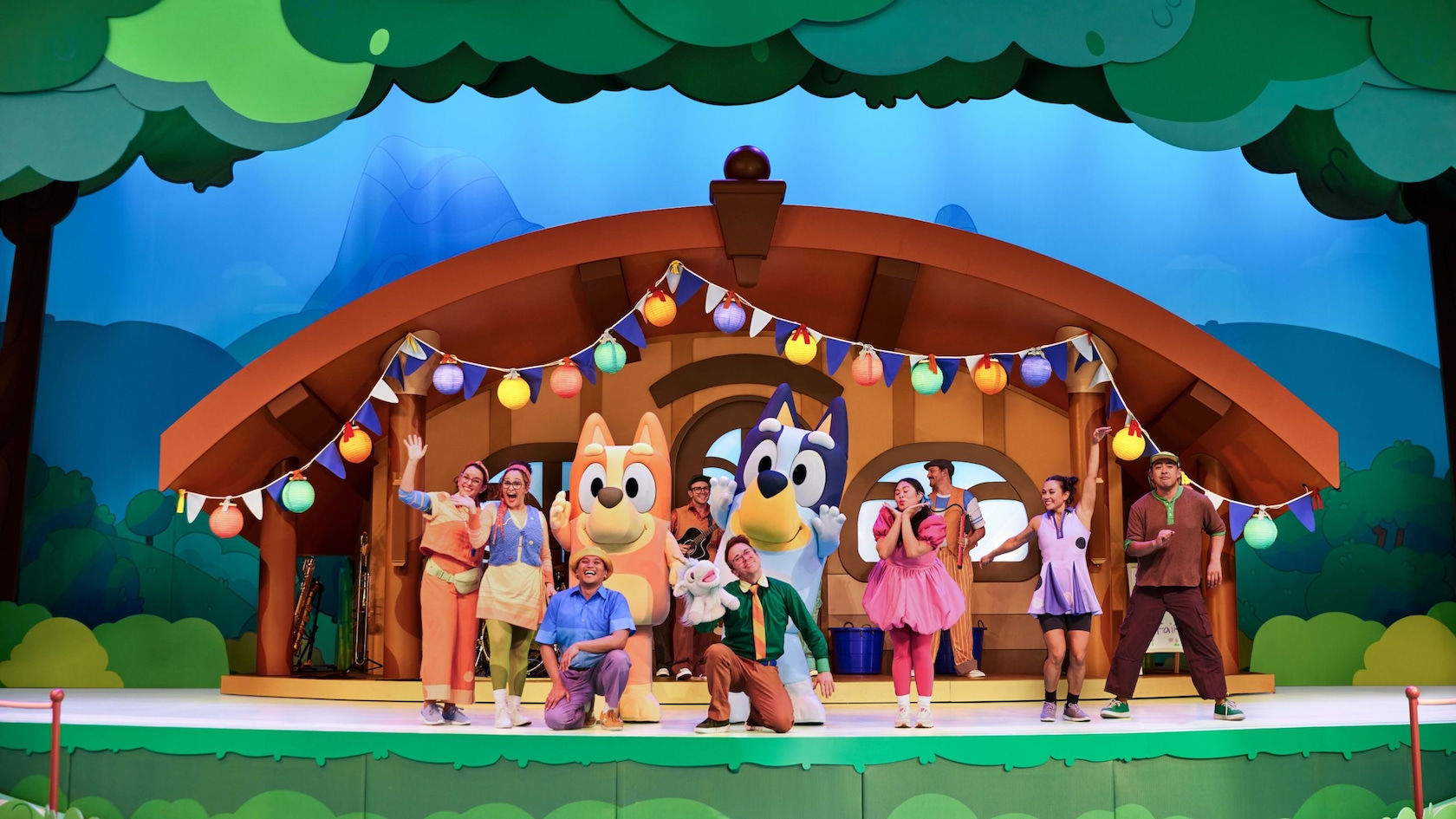 Bluey, Bingo and the cast of Bluey's Best Day Ever on the Fantasyland Theatre stage