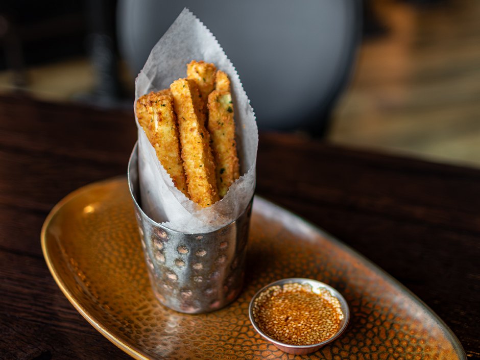 Parmesan-crusted crispy zucchini with sesame soy dipping sauce.