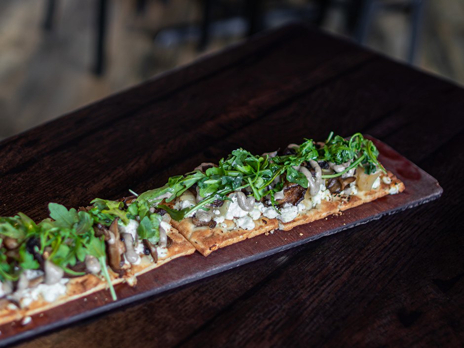 Forest Mushroom Flatbread with goat cheese, caramelized onions, arugula and truffle oil.
